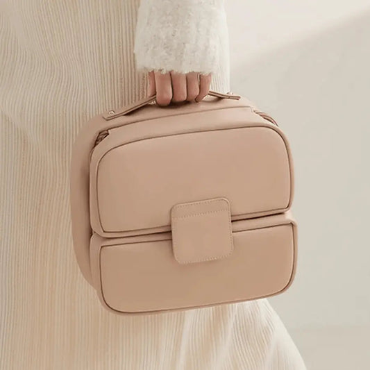 Trousse de toilette femme tendance avec poignée rose en similicuir