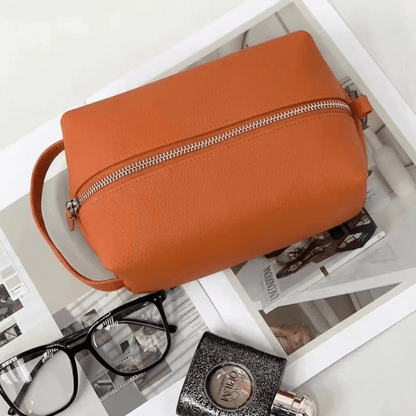 Trousse de toilette orange en cuir avec poignée côté